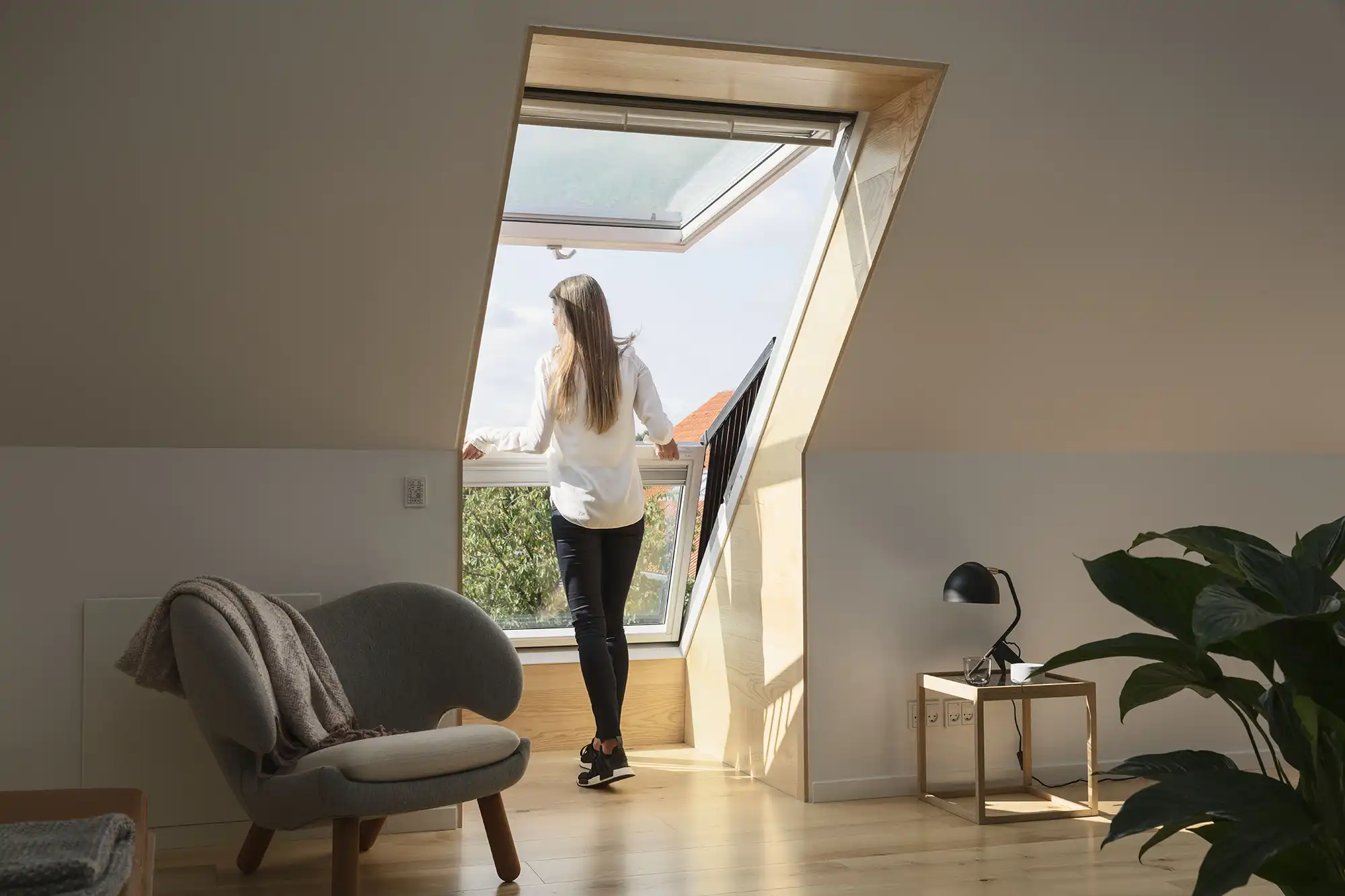 woman looking out of loft window
